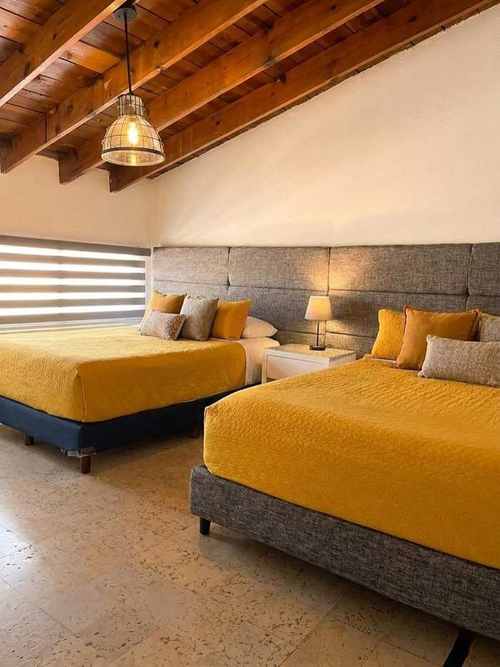 Recámara de María Jimena Suites con dos camas